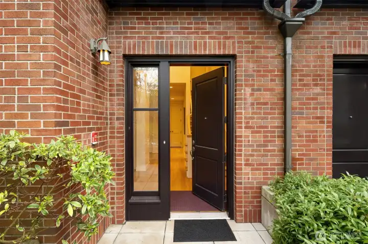 Traditional brownstone entryway with secure gate