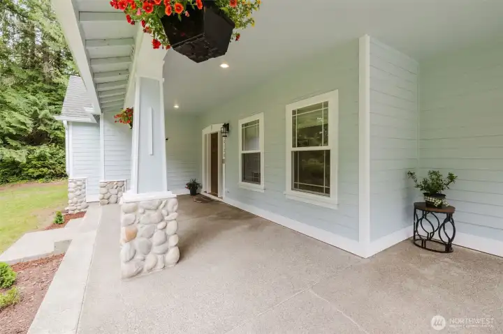 Massive covered front porch protects on rainy days and invites you to enjoy some front porch sitting.
