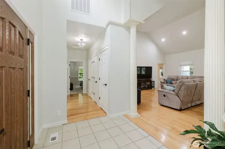 From foyer, you can see into the open living room with vast soaring ceilings.  Down the hall are the two secondary bedrooms as well as the guest bathroom.  Plenty of storage lines the hallway.
