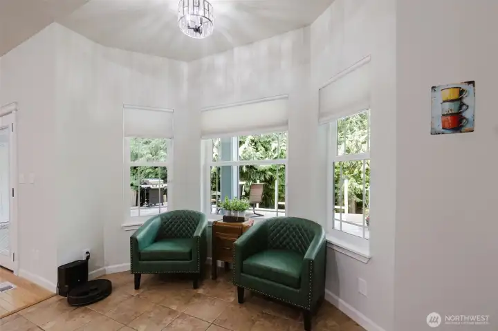 Breakfast nook currently set up as a conversation space or a cozy place to curl up with a book and a cup of tea.