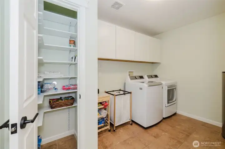 Laundry room with pantry.