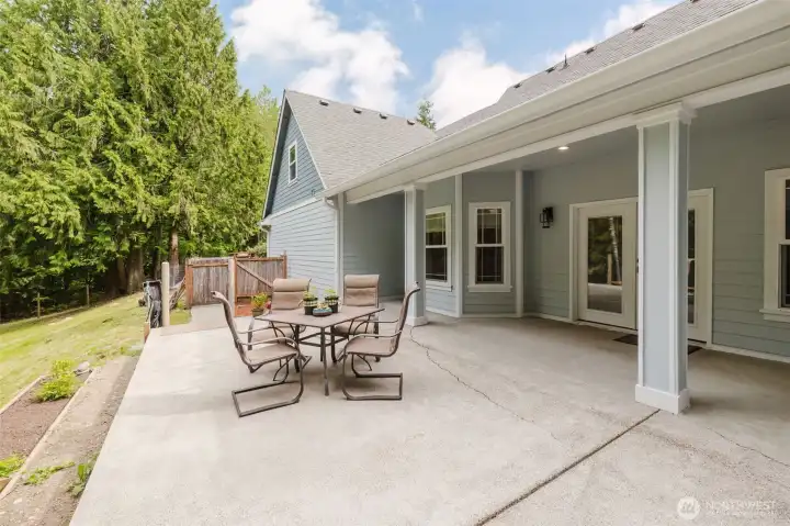 Expansive back patio has covered and uncovered space.  Bordered by raised garden beds, you can look out onto the large, private backyard.