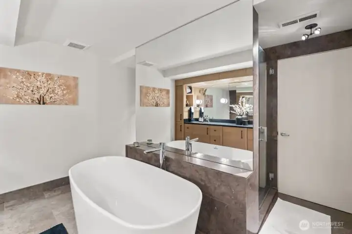 Warm wood cabinetry and sleek stone finishes elevate the space