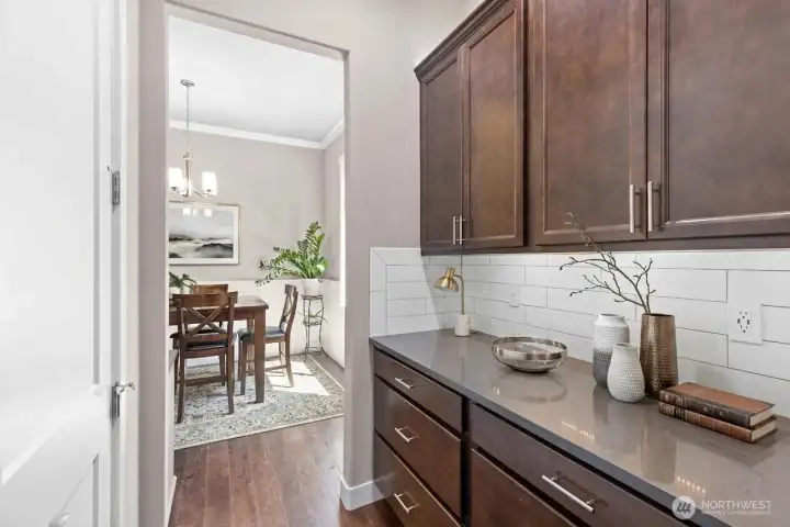 Butler's pantry and also a HUGE walk-in pantry to the left are located between the dining room and the kitchen.