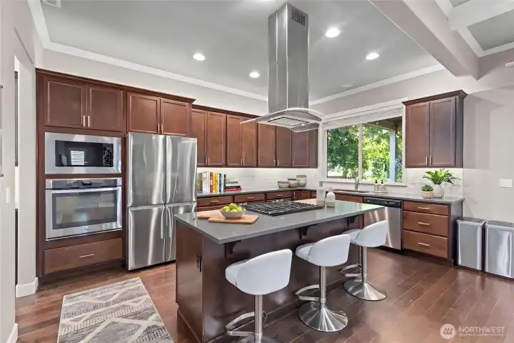 Kitchen with double ovens, natural gas cooktop in island and convenient island. *Some decor digitally staged.