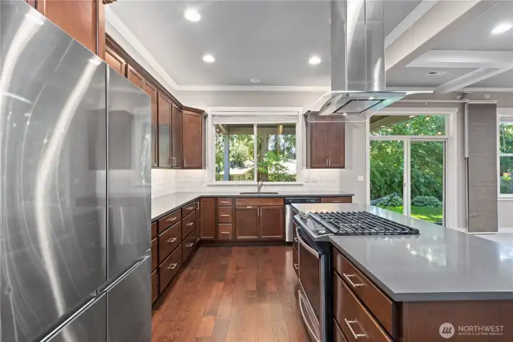 Kitchen with gleaming hardwood floors and acres of counter space for lots of workspace.