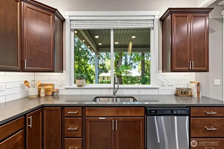 Kitchen looks out to covered patio. *Some decor digitally staged.