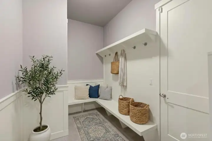 Mudroom with custom shelving off the garage. *Some decor digitally staged.