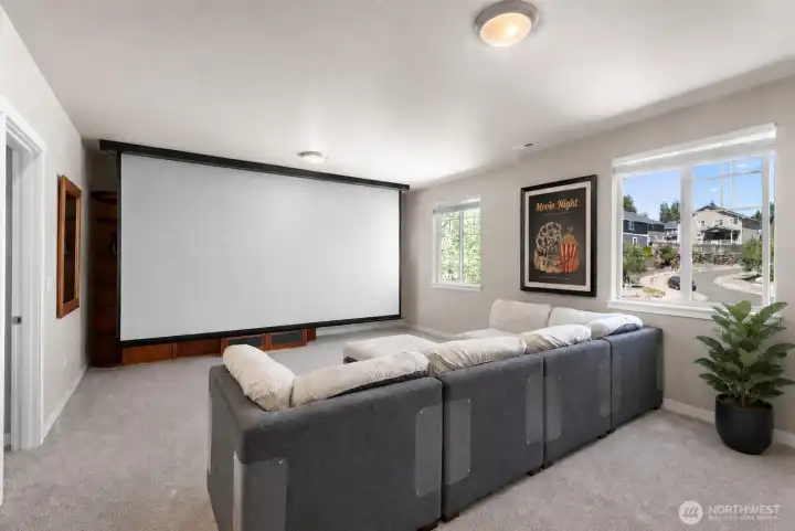 Theater room/loft with screen down. 15'screen means you never need to leave home for a great movie experience!