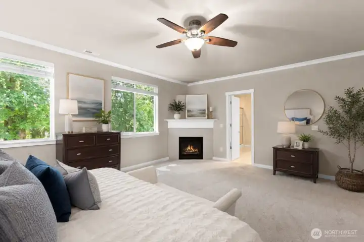 Primary bedroom with cozy gas fireplace! *Some decor digitally staged.