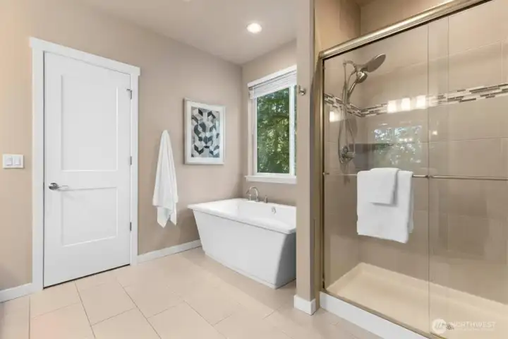 Primary bathroom has large walk in shower, soaking tub, dual sinks and a walk in closet. *Some decor digitally staged.