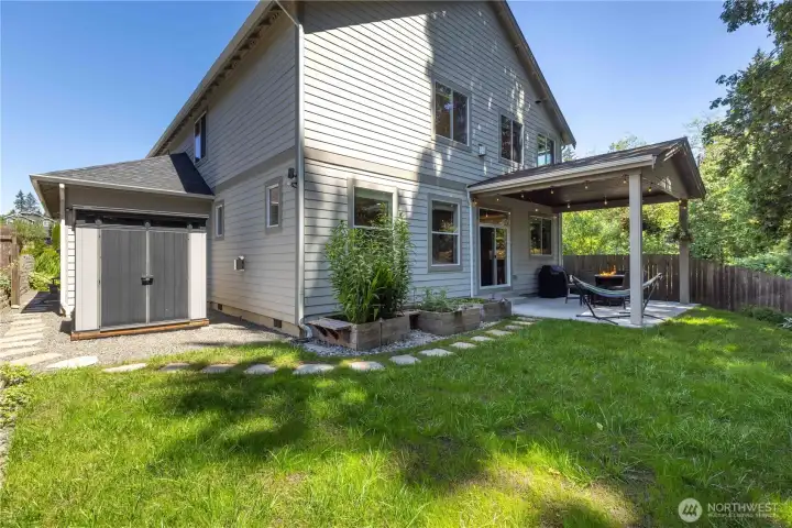 Backyard, shed and covered patio. Yard is fully fenced.