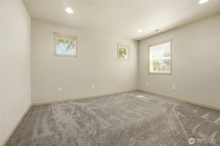 Primary bedroom features tons of light