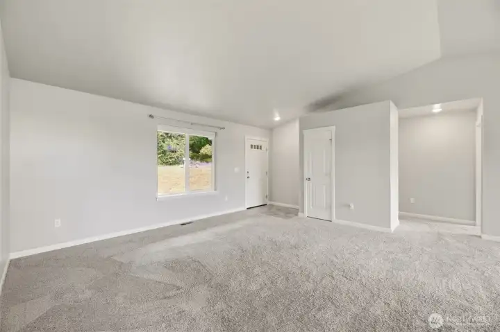 Open airy great room with coat closet at the door