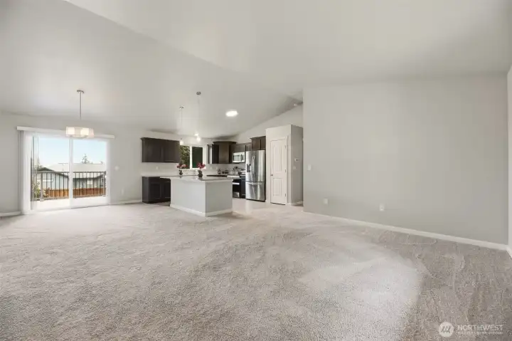 Soaring cathedral ceilings and warm natural light make the main living area feel open, airy, and much larger than expected