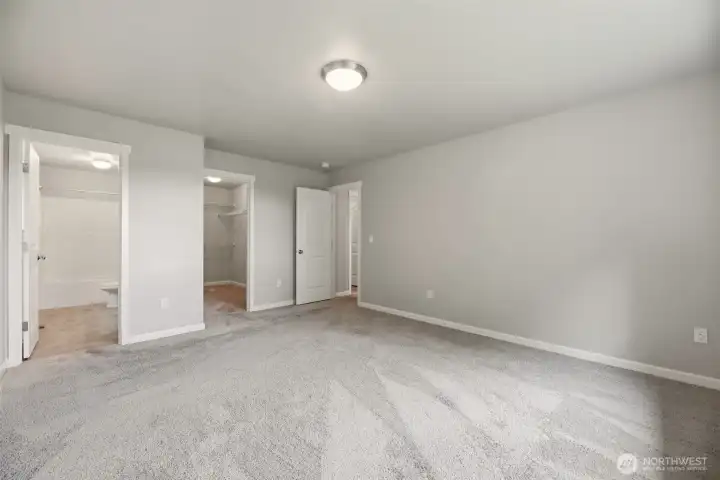 Primary suite with walk in closet, double vanity, and privacy at the opposite end of the house from the other two bedrooms