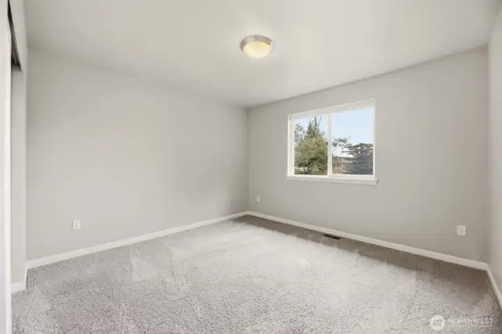 3rd bedroom with view of backyard