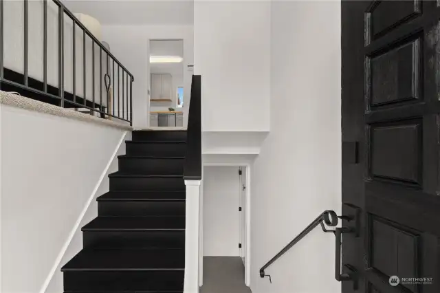 New tile and freshly painted stairs and handrails in the entryway. New light fixtures inside and out.