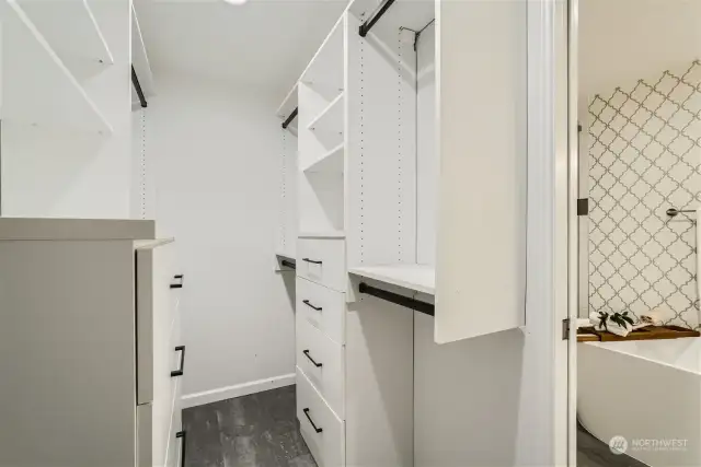 The primary bedroom's walk-in closet with custom shelving.