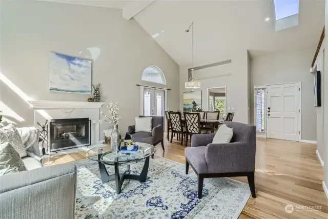 Open and airy with vaulted ceilings and a skylight in the living room and dining room. A beautiful mantled fireplace creates a warm and inviting atmosphere.