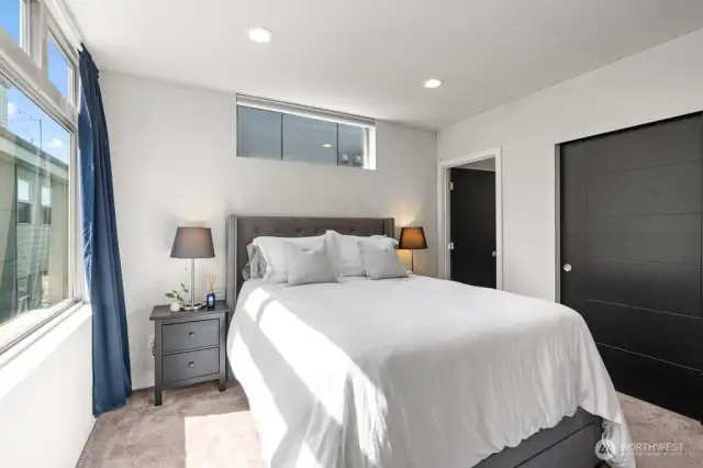 Primary bedroom has mini-split and custom closet built-ins