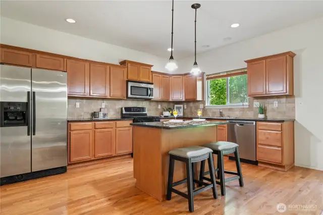 Large hardwood Kitchen with granite slab contertops