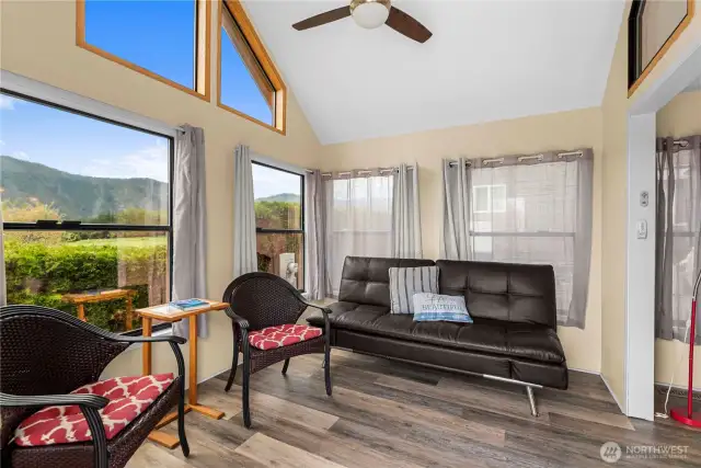 Ceiling fans in the the vaulted living room and the bedroom help circulate the heat and air provided via the heat pump.