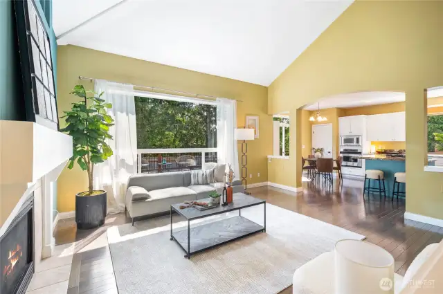 A large picture window frames the backyard view.