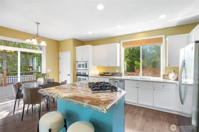 Granite countertops and stainless appliances complement this kitchen. A slider leads to the entertainment-size deck.