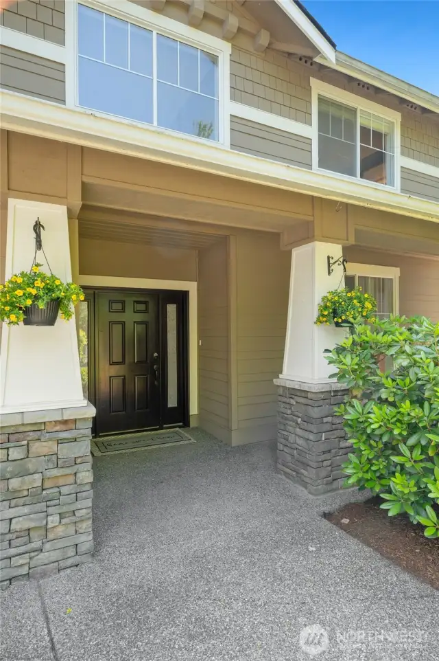 The covered front porch beckons you inside.