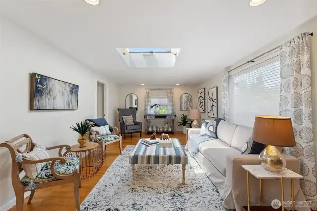 Formal living room adjacent to dining room/great room. Doorway on left to primary suite.
