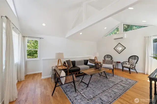 Spacious family room located in the back of the home. Staircase beyond the half wall provides access to basement.