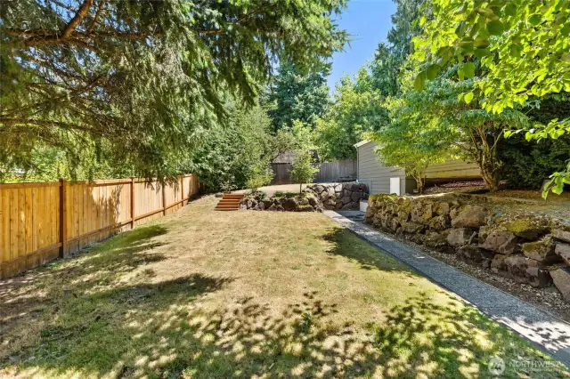 Steps down from the deck you'll find space for play and gardening. Cornhole anyone?!