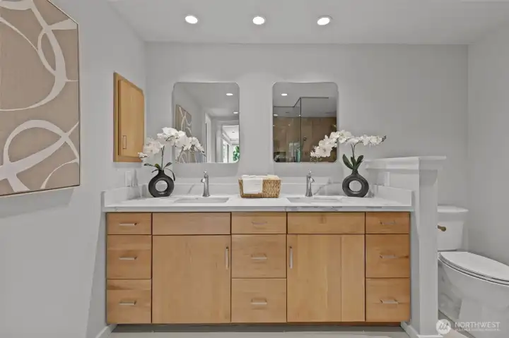 Luxurious tile floors, double sinks, and plenty of storage space make this 3/4 primary bath a must-see.