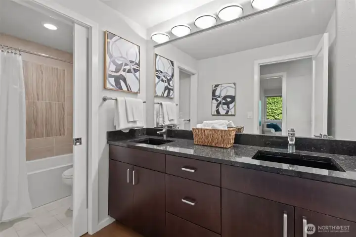 The two extra bedrooms share a fully remodeled bathroom  with undermount double sinks and beautiful tile tub/shower combo.