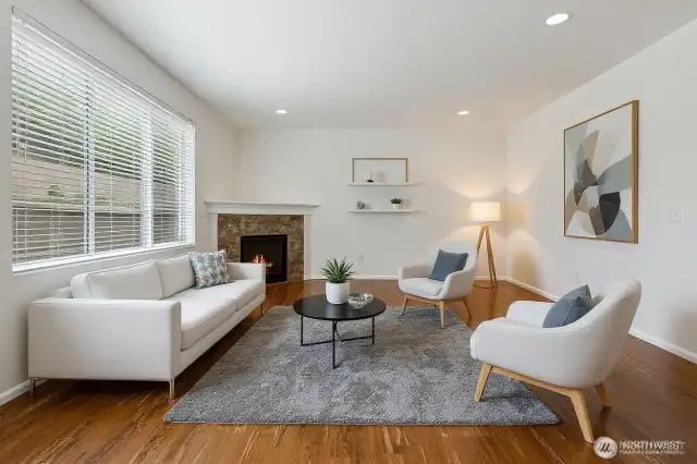 Virtually staged living room w/ cozy fireplace.