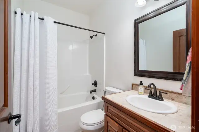 Main floor full bath with tile vanity.