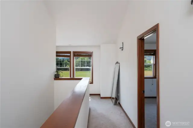 Upstairs landing/hallway, lots of natural light throughout home and vaulted ceilings upstairs.