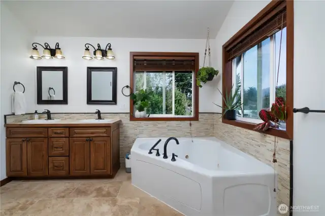 Primary bath has large jetted tub, perfect for relaxing soaks! Tile floors and surround with full shower as well.