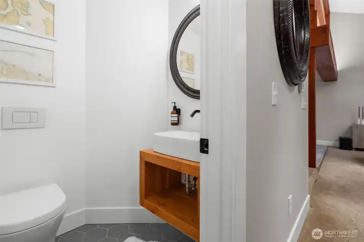 On the main floor, this half bathroom is both beautiful and functional.