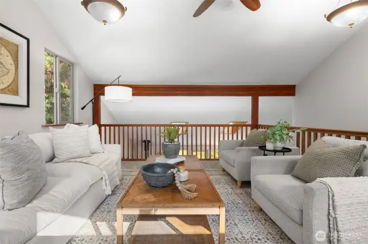 This loft area serves as an excellent secondary living area, open to the downstairs and filled with natural light.