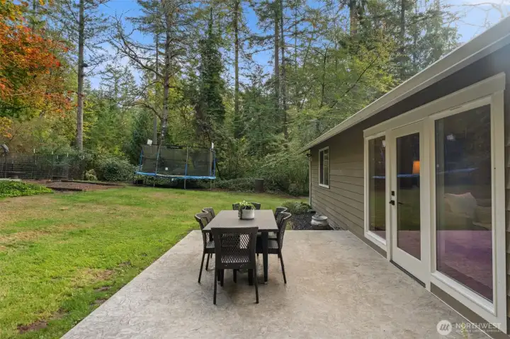 The stamped concrete patio wraps all the way from the front of the house to this back yard area off the living room.