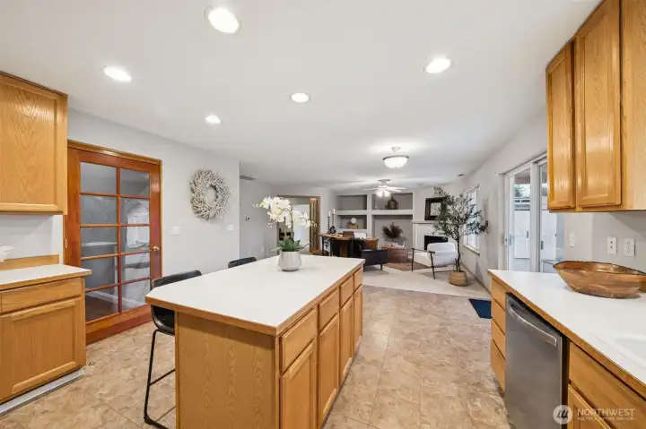 Large kitchen with new appliances, island, pantry and eating space with slider to covered patio,