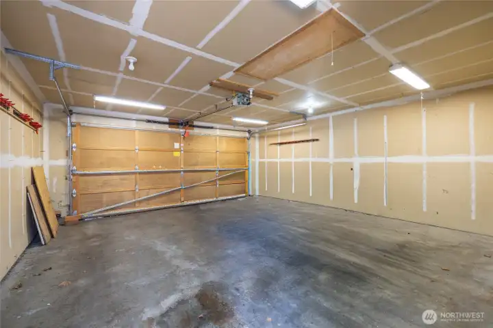 Big two car garage with plenty of room for a workbench