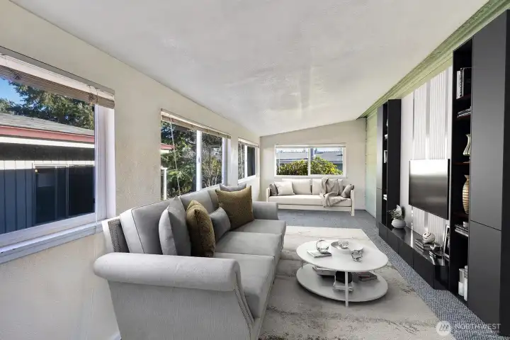 Slider from the kitchen area to this extra finished room. Make it a family room, office, exercise room. You decide.  Custom blinds give you privacy on all vinyl windows. Virtually staged .