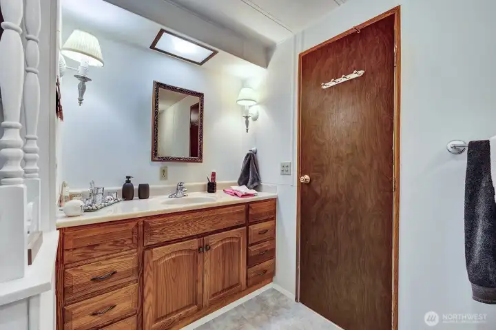 Primary bath vanity has room storage for all personal bath items. Privacy wall for the commode.