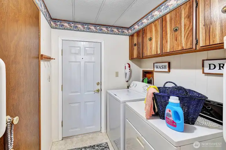 Utility room has access door to guest bath and access door to the carport area. Storage cabinets for all your laundry necessitates. Washer and dryer are included in the sale.