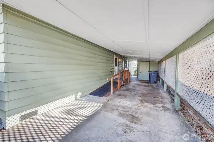 Tandem, (2) Vehicle carport. Lattice privacy on the South side. Ramp with railing for walker access into the door at the utility room into the home. Totally sheltered from the weather.