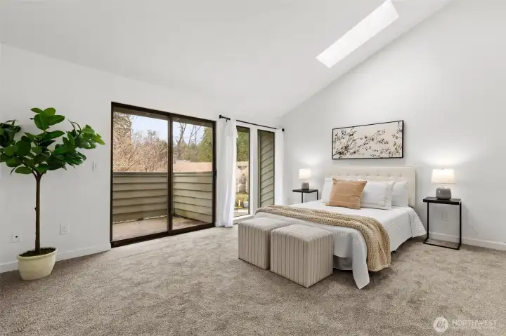 Spacious primary bedroom with private access to the upper balcony.