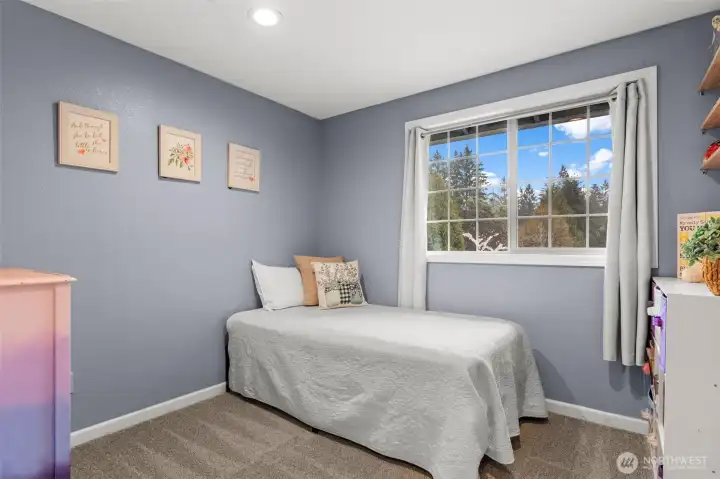 This joyful third bedroom basks in natural lighting and provides a great view of the front yard cherry blossoms!